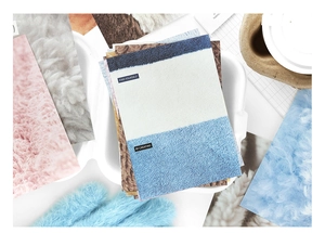 Detail of PaperMore scrapbook paper showing soft fabric textures and pastel cardstocks