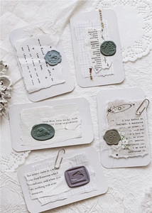 Macro detail of 3D wax seal stickers featuring embossed vintage floral and animal designs