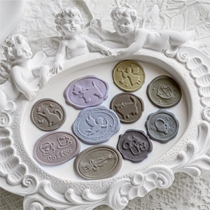 Vintage wax seal stickers with embossed coffee, angel and animal motifs in Morandi tones