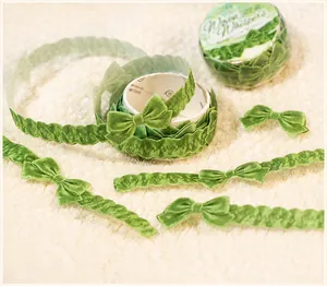 Detail showing velvet texture and laser-cut bow design of Morandi green decorative tape