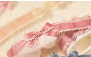 Close-up of vintage pink bow and white lace pattern on washi tape for journaling