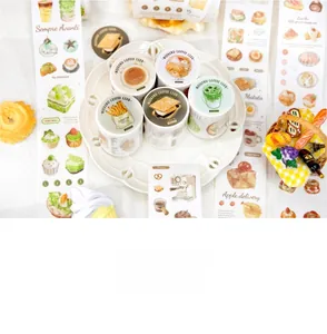 Detail showing hand-drawn coffee and dessert patterns on washi tape rolls for journaling