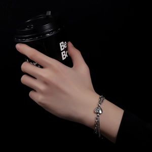 Silver double-layer titanium steel chain bracelet with heart charm on hand