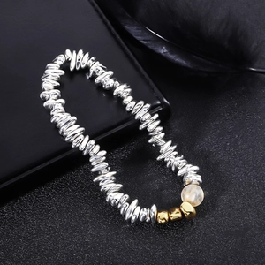 Macro view of beads featuring silver metallic hematite stones and gold accents on leather