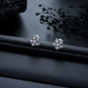 Sparkling five-petal flower stud earrings in titanium steel with zircon inlay