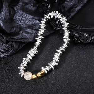 Close-up of handmade hematite beaded bracelet with silver and gold metallic accents