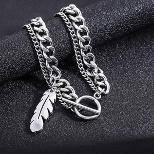Detail view of silver double-layer titanium steel chain with feather pendant and OT clasp