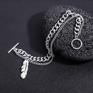 Macro view of double-layer titanium steel chain bracelet with feather pendant and OT buckle