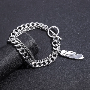 Double-layered titanium steel bracelet with feather pendant and OT clasp on black stand