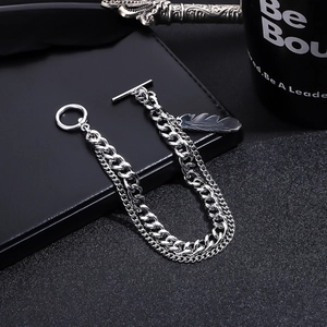 Macro shot of silver feather pendant and double layer curb chain with OT toggle clasp