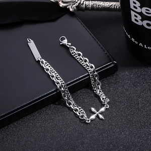 Detail of silver titanium double-layer chain bracelet with star pendant and ID plate