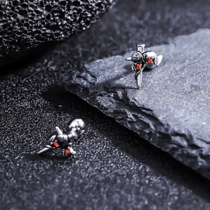 Detailed view of Gothic titanium steel studs featuring a red zircon rose and cross design