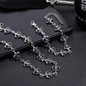 Detail of vintage silver fleur-de-lis chain necklace with lobster clasp and adjustable link