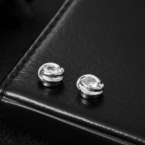 Dettaglio macro di orecchini Möbius in argento con intarsio in zircone lucido