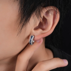 Silver-toned C-shaped hoop earrings with blue baguette zircon and side pave stones