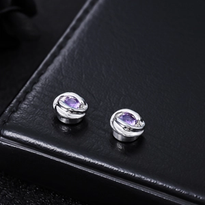 Orecchini magnetici Mobius in argento con zircone viola su base in pelle