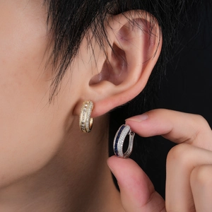 Detailed view of luxury gold hoop earrings with white zircon and blue rectangle gemstone