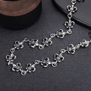 Detailed view of vintage silver fleur-de-lis chain links with gothic oxidized texture