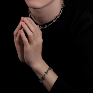 Gothic fleur-de-lis cross necklace and bracelet set in vintage silver finish on model