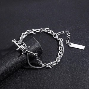 Close-up of double layer punk chain bracelet with barbed wire accent and metal tag