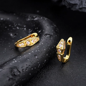 Macro detail of geometric 18K gold plated huggie earrings with sparkling cubic zirconia