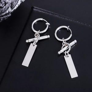 Macro shot of silver rectangular pendant earrings with mirror-polished titanium steel finish