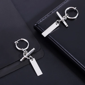 Close-up of silver titanium steel nameplate pendant clip earrings on black leather