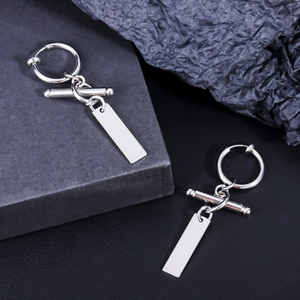 Close-up of a silver titanium steel ear clip with a minimalist rectangular tag pendant