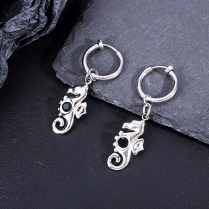 Close-up of seahorse shaped stainless steel earrings with black gemstone inlay details