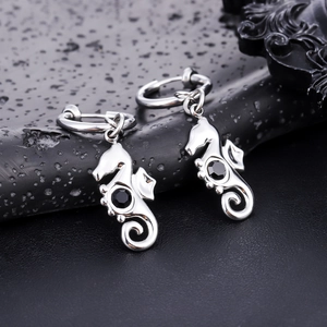 Macro view of seahorse hoop earrings in stainless steel with a black zircon stone