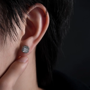 Square zircon stud earring in silver finish featuring a halo design on male model's ear