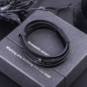 Men's multilayer black leather crown bracelet with a magnetic clasp on a gift box