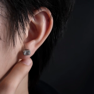 Sparkling square cut zircon stud earrings for men and women on a person ear lobe