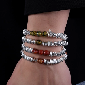 Set of four luxury beaded bracelets with silver-textured metal beads and natural gemstones