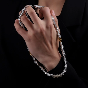 Chic silver and gold beaded necklace featuring irregular metal discs and resin stones