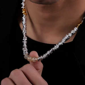 Elegant gold and silver twisted chain necklace with three translucent yellow stone beads