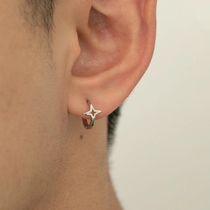 Sleek silver star drop huggie earring featuring a minimalist four-pointed star charm