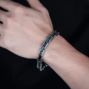 Close-up of silver and blue interlocking Cuban chain link bracelet for men in high polish