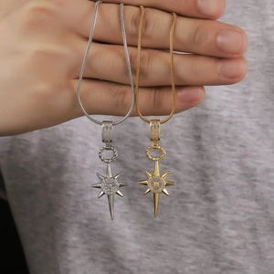 Eight-pointed star pendant necklace set in gold and silver finish with sparkling zircons