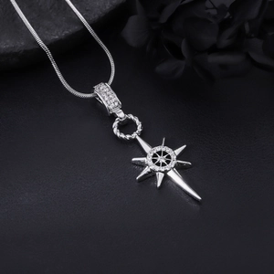 Close-up of diamond-set silver eight-pointed star pendant on a sleek snake chain