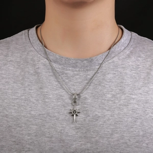 Close-up of men's eight-pointed star pendant necklace with black center on snake chain