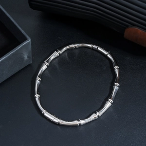 Detail view of silver stainless steel bamboo style bracelet with polished finish