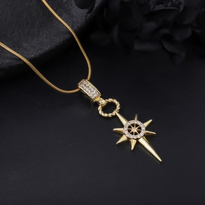 Macro shot of gold octagonal star pendant with pavé crystals on a snake chain