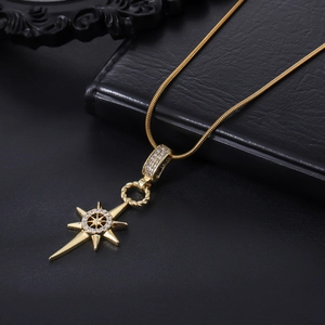Detailed view of gold octagram compass pendant with sparkling zircon micro-pave setting