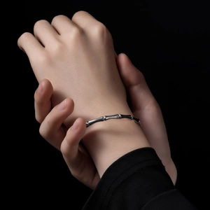 Polished stainless steel bamboo joint bracelet with minimalist aesthetic on wrist