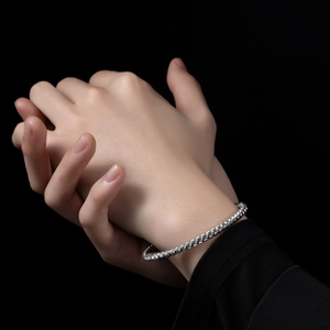 Minimalist silver braided stainless steel screw bracelet with spiral twisted texture