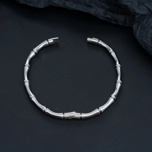 Close-up of polished stainless steel bamboo joint bracelet with secure clasp closure