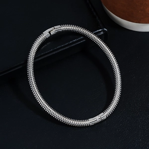 Macro shot of silver stainless steel spiked multi-layer bracelet with mechanical clasp