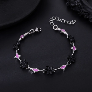 Detailed shot of Gothic star chain bracelet with black flower and purple enamel accents