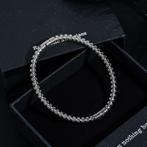 Macro shot of silver stainless steel beads with spiral textures and luxury gift box